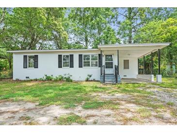 Charming single-story home featuring a covered porch and well-maintained front yard at 512 W Baptist St., Marion, SC 29571