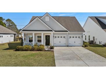 Charming single-Gathering home with a well-manicured lawn and an attached two-car garage at 617 Cherry Blossom Dr., Murrells Inlet, SC 29576