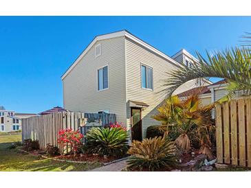 Charming home exterior featuring a well-manicured lawn and tropical landscaping at 800 9Th Ave. S # R-3, North Myrtle Beach, SC 29582