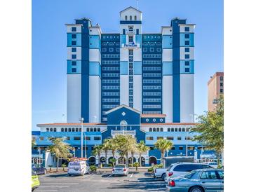 The blue and white exterior of a beachfront building is seen on a clear, sunny day at 2201 S Ocean Blvd. # 1603, Myrtle Beach, SC 29577