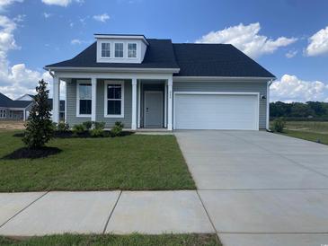 Charming, single story home features a 1-car garage, light green siding and covered front porch at 242 Letha Dr, Longs, SC 29568