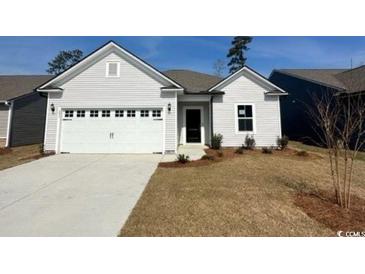 Charming single-story home with a two-car garage and well-maintained lawn on a sunny day at 293 Eagle Claw Dr., Calabash, NC 28467