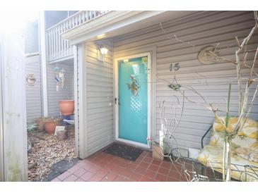 Charming condo featuring a vibrant turquoise front door and decorative exterior accents at 312 73Rd Ave. N # 15, Myrtle Beach, SC 29572