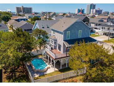 Beautiful home with a private pool, white picket fence, a deck, and views of the surrounding neighborhood and skyline at 406 26Th Ave N, North Myrtle Beach, SC 29582