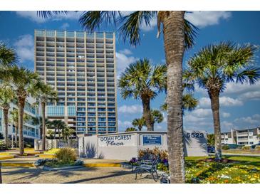 Ocean Forest Plaza condo building with lush landscaping, palm trees, and signage on a bright, sunny day at 5523 N Ocean Blvd. # 1513, Myrtle Beach, SC 29577