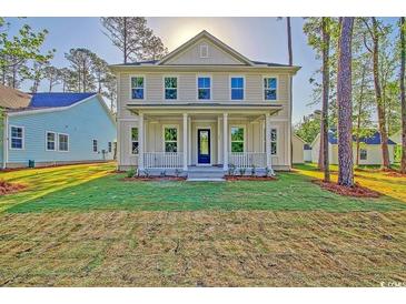 Charming two-story home with a welcoming front porch and manicured lawn at 82 Bridgeview Rd., Georgetown, SC 29440