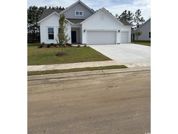 Charming single-Gathering home featuring a three-car garage and a well-manicured front yard at 179 Glengrove Lane, Murrells Inlet, SC 29576