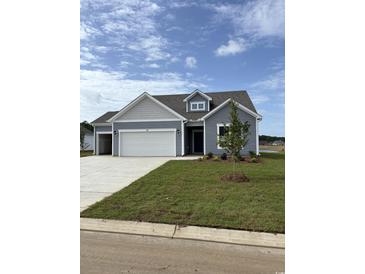 Charming single-Gathering home with a three-car garage, manicured lawn, and classic curb appeal at 180 Glengrove Lane, Murrells Inlet, SC 29576