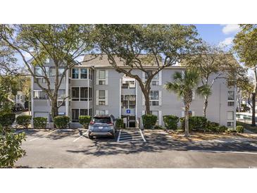 Attractive three story condo building with covered entry, landscaping, and reserved parking at 351 Lake Arrowhead Rd. # 131, Myrtle Beach, SC 29572