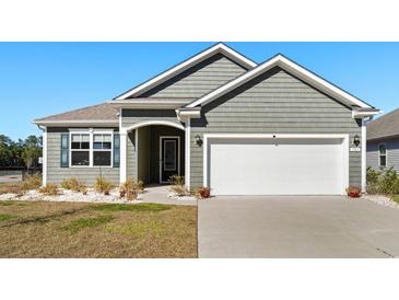 Charming home exterior featuring a well-maintained lawn, and attached two-car garage at 781 Flowering Branch Ave., Little River, SC 29566