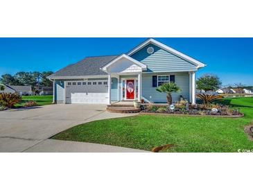 Charming single-story home with a well-manicured lawn, attached garage, and inviting red front door at 1525 Sunmeadow Dr., Conway, SC 29526