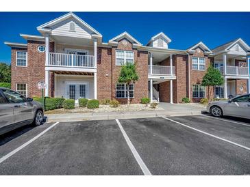 Brick condo building featuring multiple stories, white trim, and manicured landscaping at 2005 Silvercrest Dr. # 32-B, Myrtle Beach, SC 29579