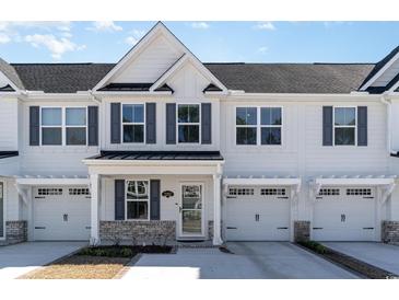 Charming white townhouse with a private garage and modern architectural details at 2352 Elowen Ln. # 22B, Longs, SC 29568