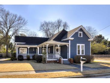 Charming blue home with inviting front porch and manicured lawn at 309 W Bond St., Marion, SC 29571