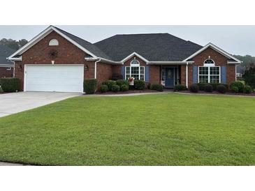 Charming one-story brick home with a well-manicured lawn and attached two-car garage at 3516 Queens Harbour Blvd., Myrtle Beach, SC 29588
