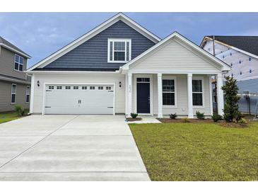 Charming two-story home with a manicured lawn and attached two-car garage, showcasing modern design at 4036 Bucolic Loop, Myrtle Beach, SC 29588