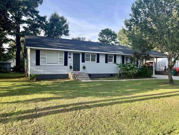 Charming single-story home featuring a well-maintained lawn, complementary shutters, and inviting curb appeal at 412 Olive St., Georgetown, SC 29440
