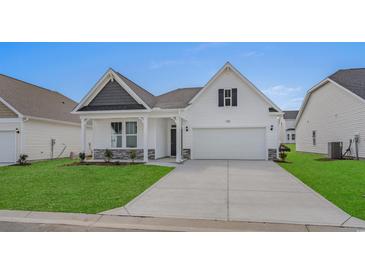 Charming one-story home with white siding, a two-car garage, and a well-manicured lawn at 1204 Nw Calabash Station Blvd., Calabash, NC 28467