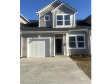 Charming home featuring a garage and traditional architectural details on a sunny day at 189 Talladega Dr. # 433, Myrtle Beach, SC 29579