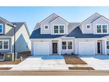 Charming new construction townhome with light gray siding, dark roof, and a one-car garage at 316 Brackish Dr. # 316, Myrtle Beach, SC 29588