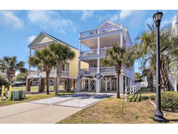 Bright beach house featuring multiple levels, decks, palm trees, and convenient ground-level parking at 512B S Ocean Blvd., Surfside Beach, SC 29575