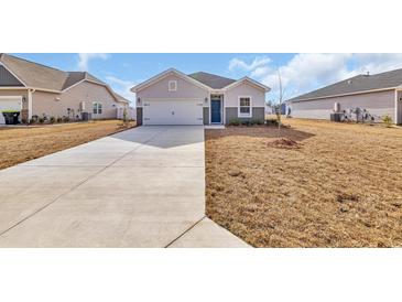 Charming single-story home featuring a two-car garage and a neatly kept front lawn at 545 Honeyhill Loop, Conway, SC 29526