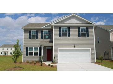 Charming two-story home with a well-maintained lawn, dark shutters, and a bright white garage door at 1004 Garden Sprout Dr, Galivants Ferry, SC 29544