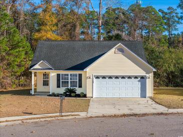 Charming single-story home with yellow siding, a well-manicured lawn, and an attached two-car garage at 1108 Patricia Ct., Conway, SC 29526