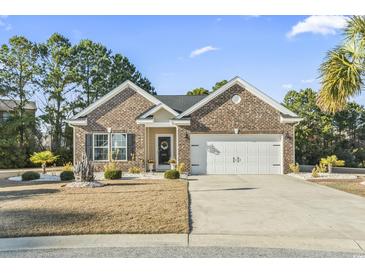 Charming brick home with a well-manicured lawn, two-car garage, and a welcoming front porch at 1412 Rainsbrook Ct., Conway, SC 29526