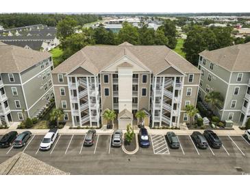 This is an aerial view of the exterior of the building showing the covered staircases and parking at 181 Ella Kinley Circle # 305, Myrtle Beach, SC 29588