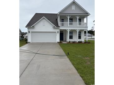 Charming two-story home featuring a welcoming front porch, a two car garage and manicured lawn at 2520 Brescia St., Myrtle Beach, SC 29579