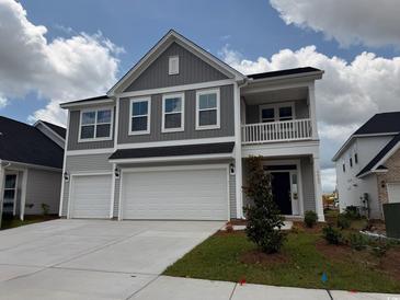 Charming two-story home boasts a two-car garage and a welcoming front porch at 4043 Bucolic Loop, Myrtle Beach, SC 29588