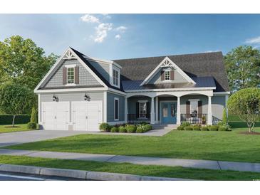 Charming two-story home featuring a covered front porch, blue front door and a two-car garage at 410 44Th Ave. N, Myrtle Beach, SC 29577