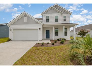 Charming two-story home featuring a welcoming front porch and a well-maintained lawn at 816 Wailea Circle, Little River, SC 29566