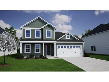 Charming two-story home showcasing a well-manicured lawn, attached garage, and complementary shrubbery at 900 Agostino Dr., Myrtle Beach, SC 29579