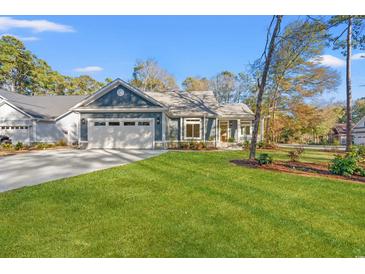 Charming single-story home boasts a two-car garage, manicured lawn, and inviting curb appeal at 1001 Brantley L Brantley Ln., North Myrtle Beach, SC 29582
