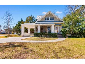 Charming two-story home with a covered carport and inviting front porch at 112 S Rosemary Ave., Andrews, SC 29510