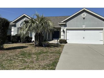 Charming single-story home with a well-manicured lawn and attached two-car garage at 1651 Fairforest Ct., Conway, SC 29526