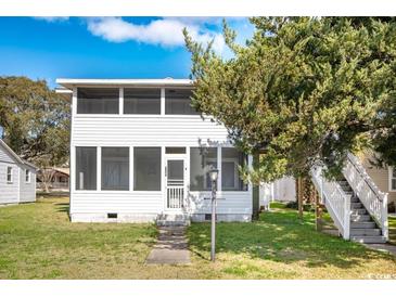 Charming two-story home with a screened porch and lovely landscaping at 2602 Perrin Dr., North Myrtle Beach, SC 29582