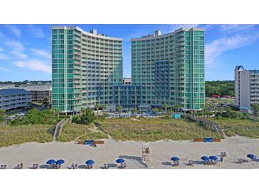 Beautiful beachside condo complex with manicured dunes and ocean views under clear blue skies at 300 N Ocean Blvd. # 1026, North Myrtle Beach, SC 29582