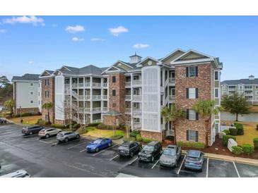Beautiful condo complex featuring brick accents, multiple balconies, and ample parking at 4875 Luster Leaf Circle # 202, Myrtle Beach, SC 29577