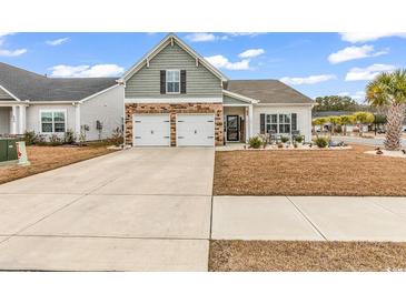 Charming home featuring a two-car garage, well-manicured lawn, and inviting curb appeal at 500 Canborough Lane, Murrells Inlet, SC 29576