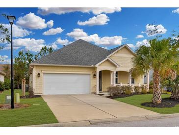 Charming single-story home showcasing a well-manicured lawn, driveway, and an attached two-car garage at 518 Heartland Ct., Murrells Inlet, SC 29576