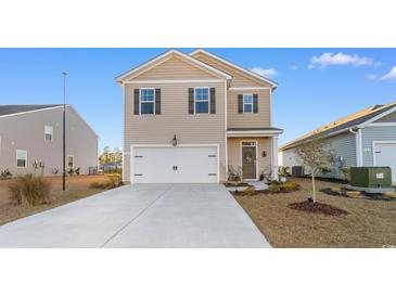 Charming two-story home with a modern exterior, attached garage, and well-manicured lawn and landscape at 706 Gryffindor Dr., Little River, SC 29566