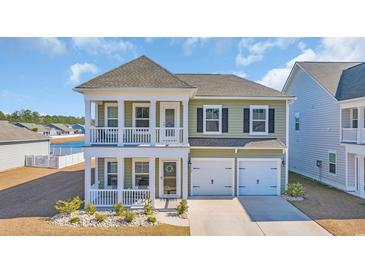 Charming two-story home with a double porch, attached two-car garage and nicely manicured lawn at 738 Harrison Mill St., Myrtle Beach, SC 29579