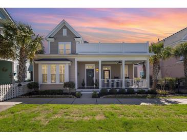 Charming home with front porch, second story balcony, manicured lawn, and beautiful landscaping at 768 Satterwhite Way, Myrtle Beach, SC 29577