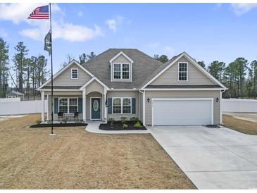 Inviting single-Gathering home boasting a two-car garage and manicured front yard at 10015 W Highway 19, Loris, SC 29569