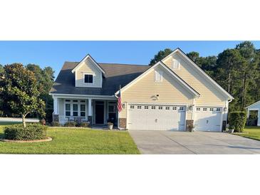 Charming home with a two-car garage, well-kept lawn, and an inviting front porch at 1201 Ficus Dr., Myrtle Beach, SC 29579