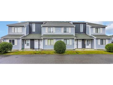 Charming townhome with gray siding, white shutters, and well-maintained landscaping at 3700 Golf Colony Lane # 18-I, Little River, SC 29566