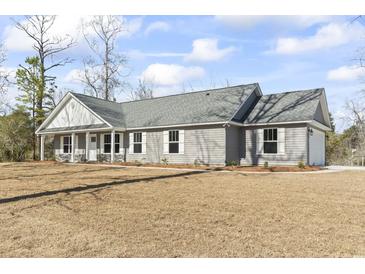 Charming single story home with gray siding, white trim, and a well-manicured front yard at 4344 Jones Rd., Myrtle Beach, SC 29588